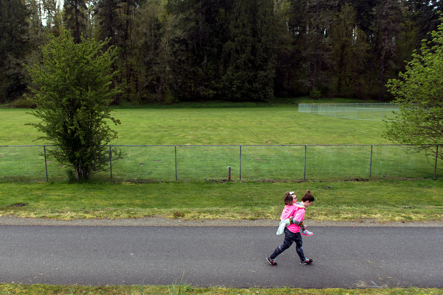 A woman carries a child on her back along the Yelm-Rainier-Tenino Trail in this file photo.