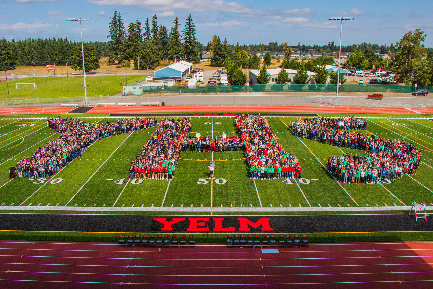 Yelm students and staff, among others, form "YHS" on the school's new turf during a celebration ceremony with the Seahawks last September. 