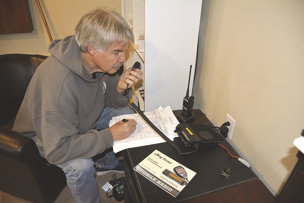 Pat Cooley, a ham radio participant, operates the radio at one of Rainier’s shelter locations — Valley Heart Assembly of God.