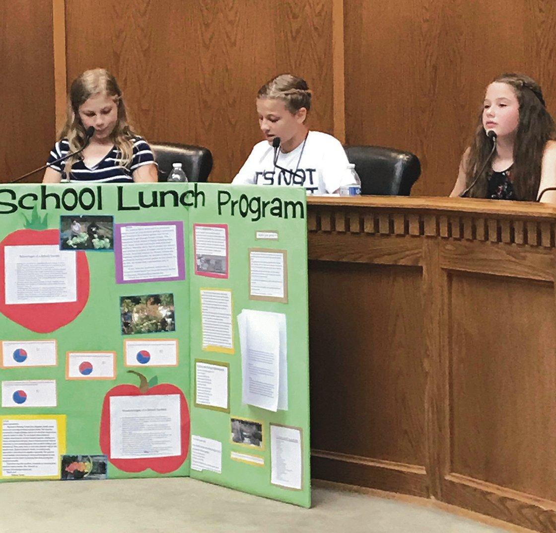 In the top photo are from left to right: Samantha Sneed, Bethany Venuto and Tyra Gaskins present on the solution of having a school garden, where we are able to add veggies and greens to our school lunches. They have investigated many possible solutions to the problem of unhealthy school lunches. Students not pictured: Taylor Gaskins, Lillian Goodwin and Maiya Mohrweis.