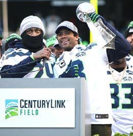 Marshawn Lynch (left) and Russell Wilson celebrate with the Lombardi Trophy during the Seahawks Super Bowl celebration at CenturyLink Field in Seattle on Feb. 5, 2014.