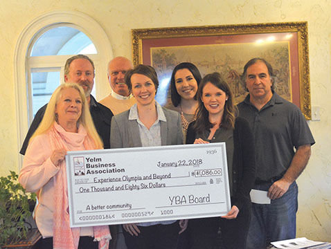 Former Yelm Business Association Executive DirectorDan Crowe (top left to right), Secretary Steve Klein, Experience Olympia Marketing Coordinator Sarah Moore, Bill Hashim, Cynthia Schmier (bottom left), Experience Olympia CEO Shauna Stewart and Experience Olympia Marketing and Communications Director Moira Davin all pose with Experience Olympia's new giant check.