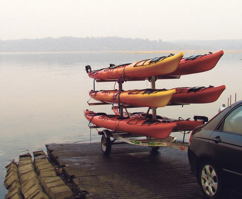Sam Kaviar loads up six kayaks Tuesday evening into the Nisqually Delta.