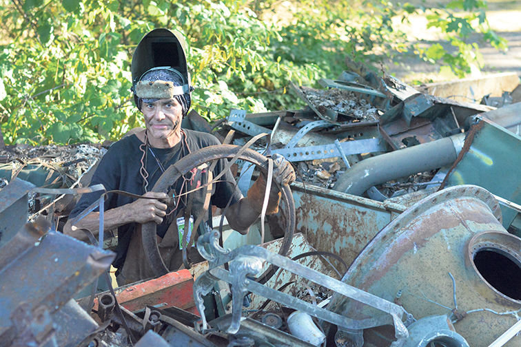 Joseph Jilbert Jojo connects with scrap metal on a property in the McKenna area Tuesday afternoon. Jojo is creating a spaceship for UFO Fest. He is considered on the leading, cutting edge of scrap metal sculptor and is revered internationally.