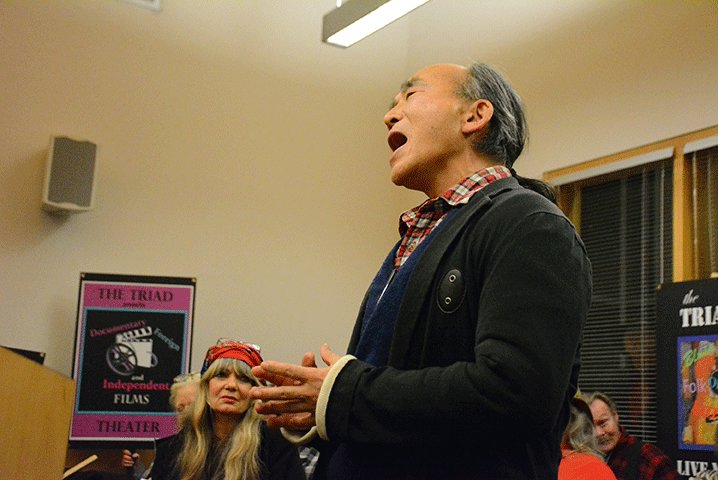 Yukio Masouva sings to the Yelm City Council on Tuesday to help gain support for an arts commission. At left in the background is Triad Theater Manager Cameron Jayne.