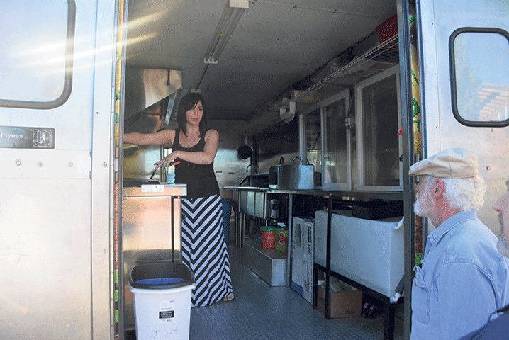 Butt Naked Organics owner Aria Cissney talks to a few people about how her food truck operates.