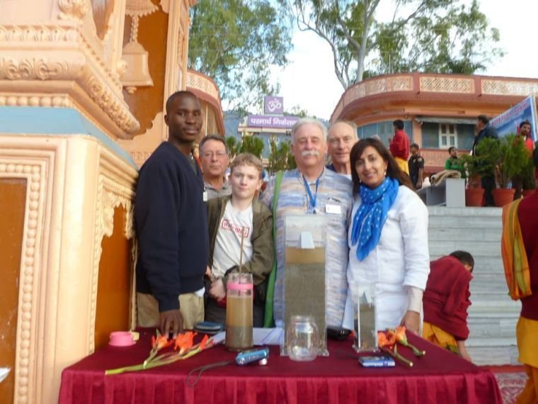 Noah Medrud, an alumni of the Phoenix Rising School, is pictured in India (front second from left), along with his father Wayne Medrud. They are part of a worldwide effort to provide clean water to remote areas.