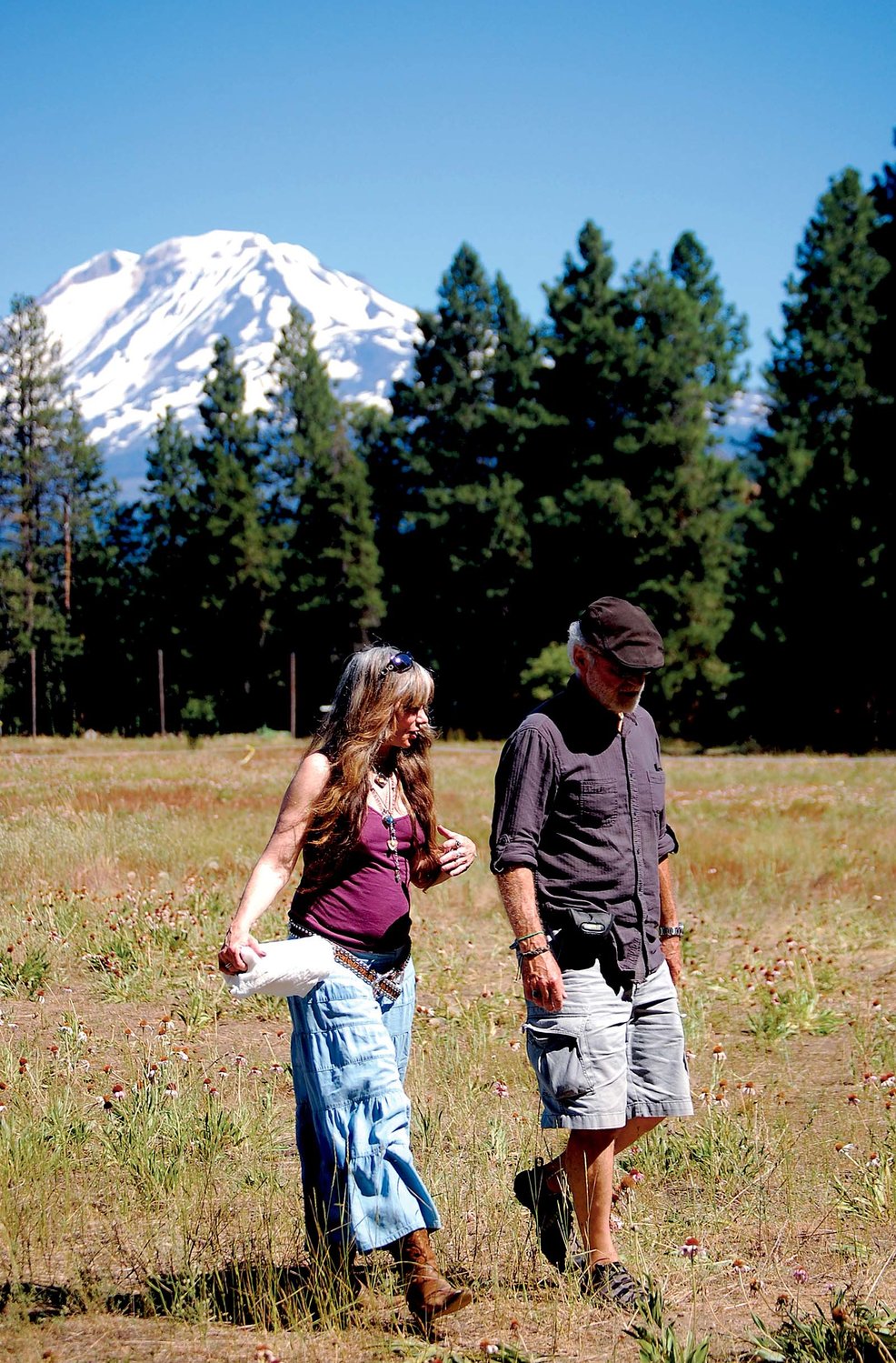 Calamity Jane, owner of the Triad Theater in Yelm, and Steven Craig, UFO tour guide, in a UFO watching field near Trout Lake at the base of Mt. Adams in the Gifford Pinchot National Forest on Saturday.