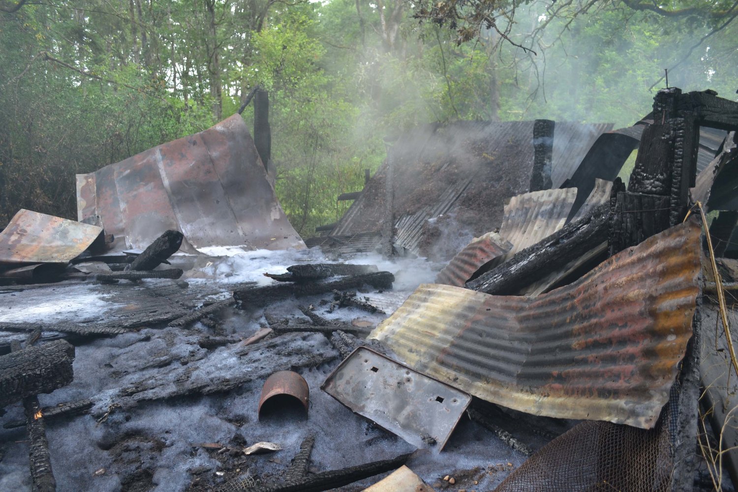 Firefighters put out a fire that destroyed a barn-like structure in the woods near Four Corners in Yelm Thursday morning.