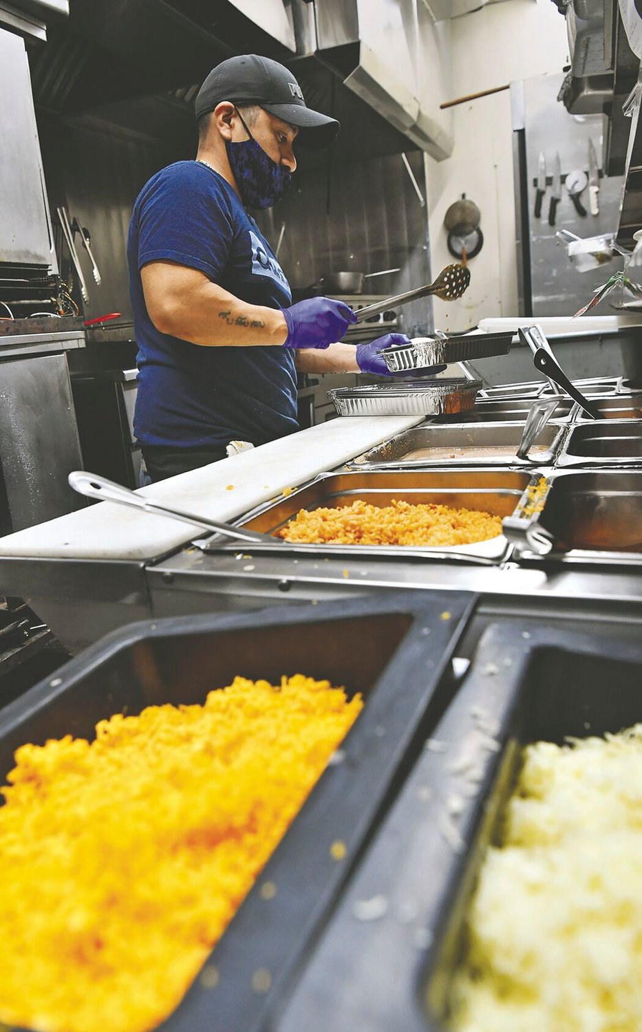 Andres Robles, 37, a cook at Puerto Vallarta restaurant in Yelm, prepares a take-out meal on Tuesday, Nov, 24.