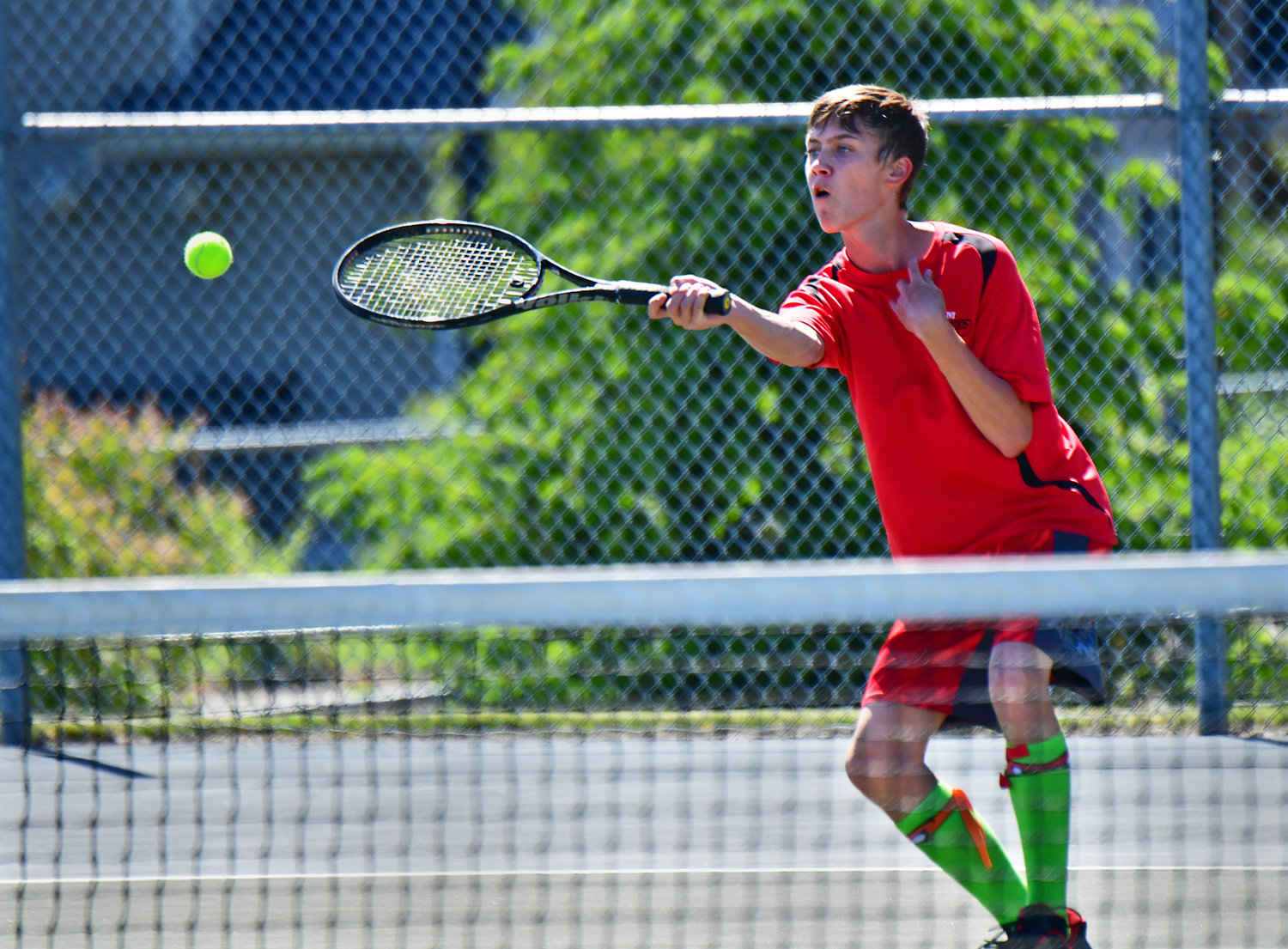 Yelm High School No. 2 boys tennis player Jacob Hensley drops a shot over the net during his match against his opponent from River Ridge High School on Wednesday, June 2, in Lacey.