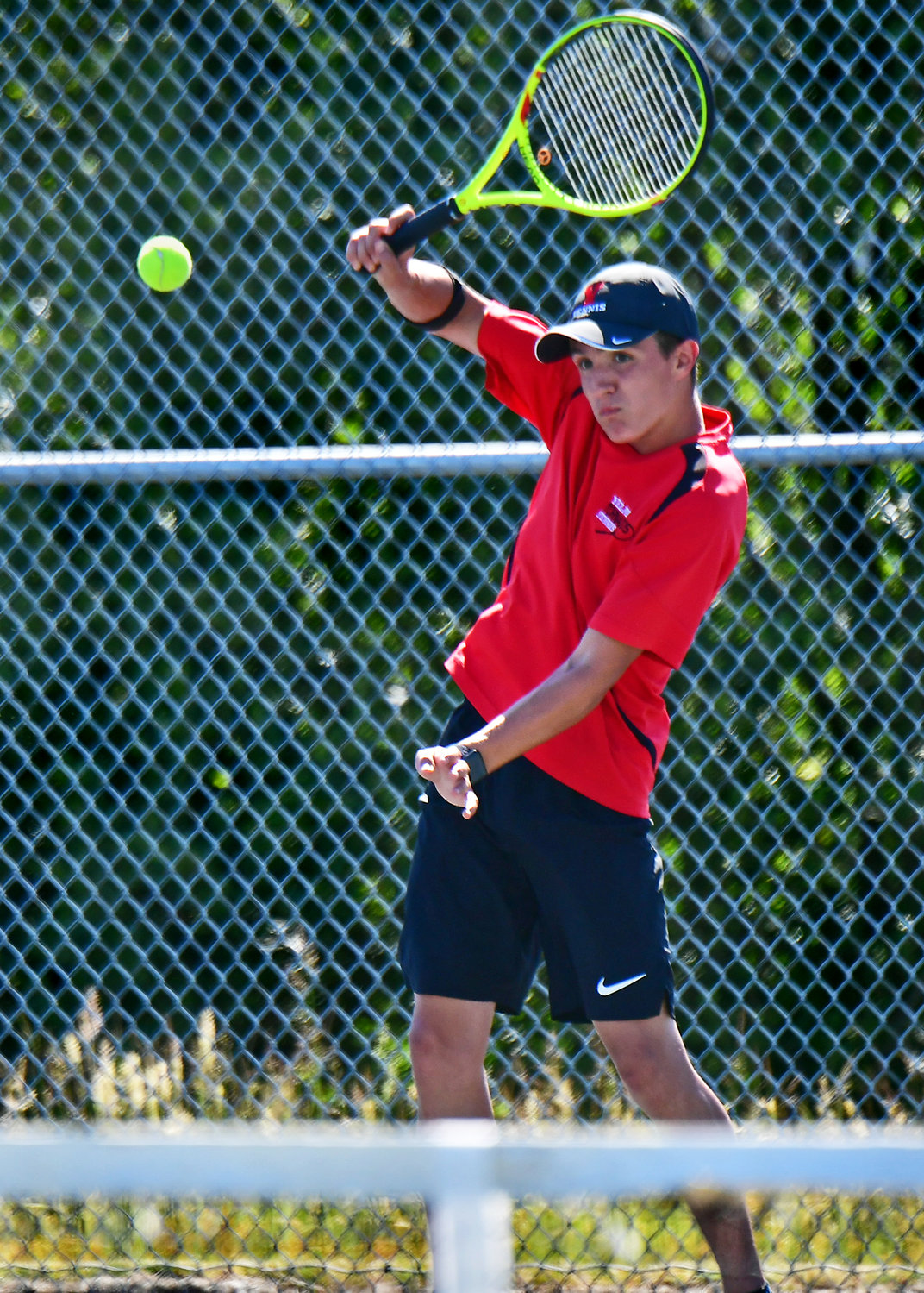Hunter Cayford, one-half of the Yelm High School No. 1 boys doubles tennis duo, smacks a serve back to his doubles opponents from River Ridge High School on Wednesday, June 2, in Lacey.