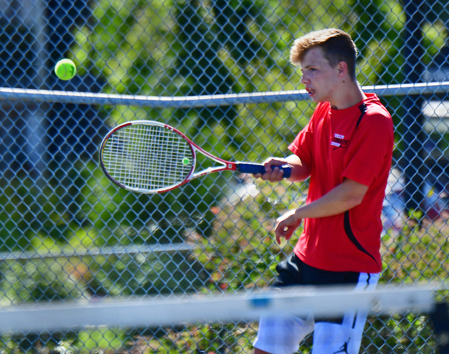 Thomas Smith, one-half of the Yelm High School No. 1 boys doubles tennis duo, lobs a serve back to his doubles opponents from River Ridge High School on Wednesday, June 2, in Lacey.