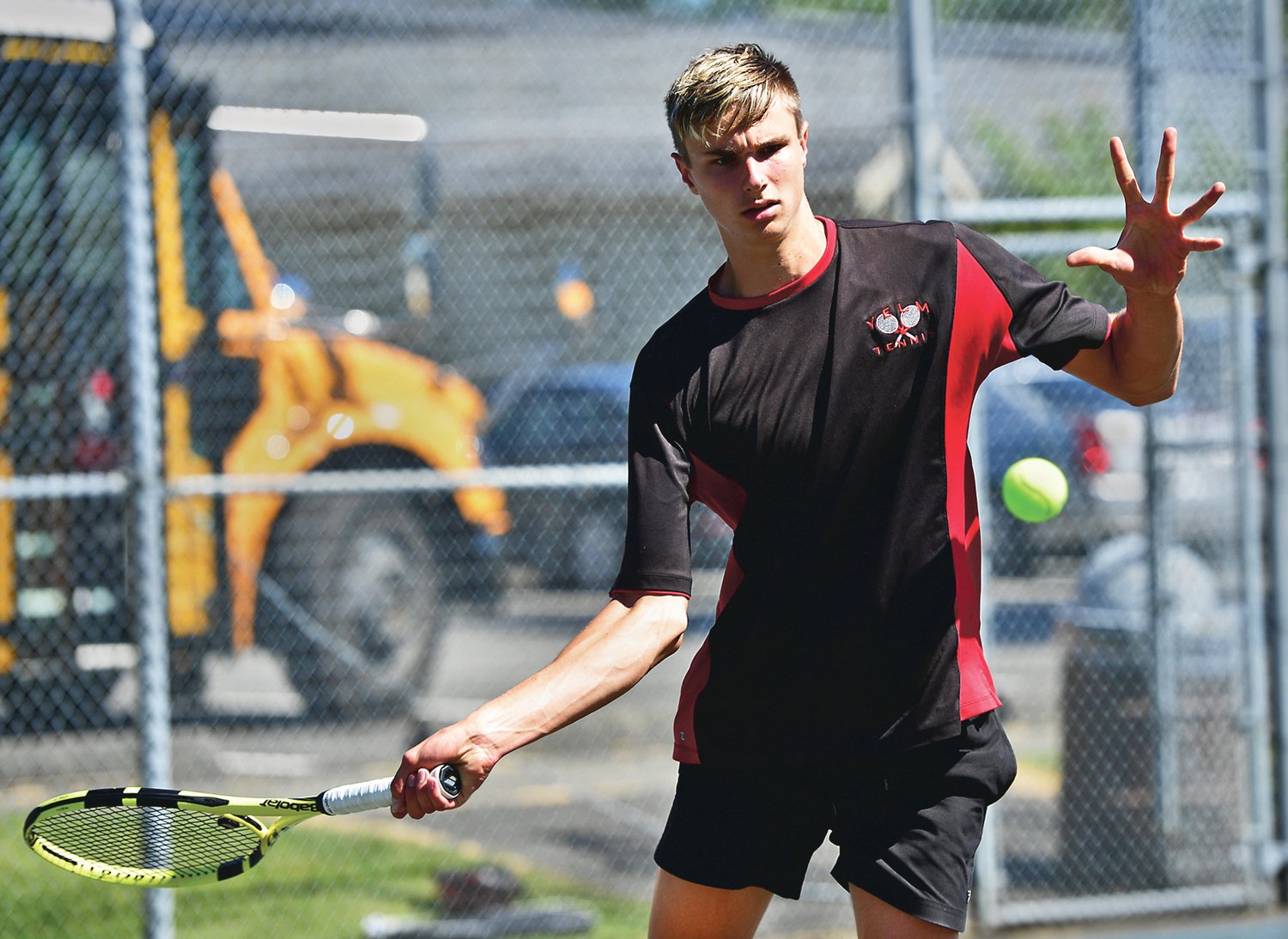 Yelm High School No. 1 boys tennis player Oliver Busina gets set to whack a forehand during his match against his opponent from River Ridge High School on Wednesday, June 2, in Lacey.