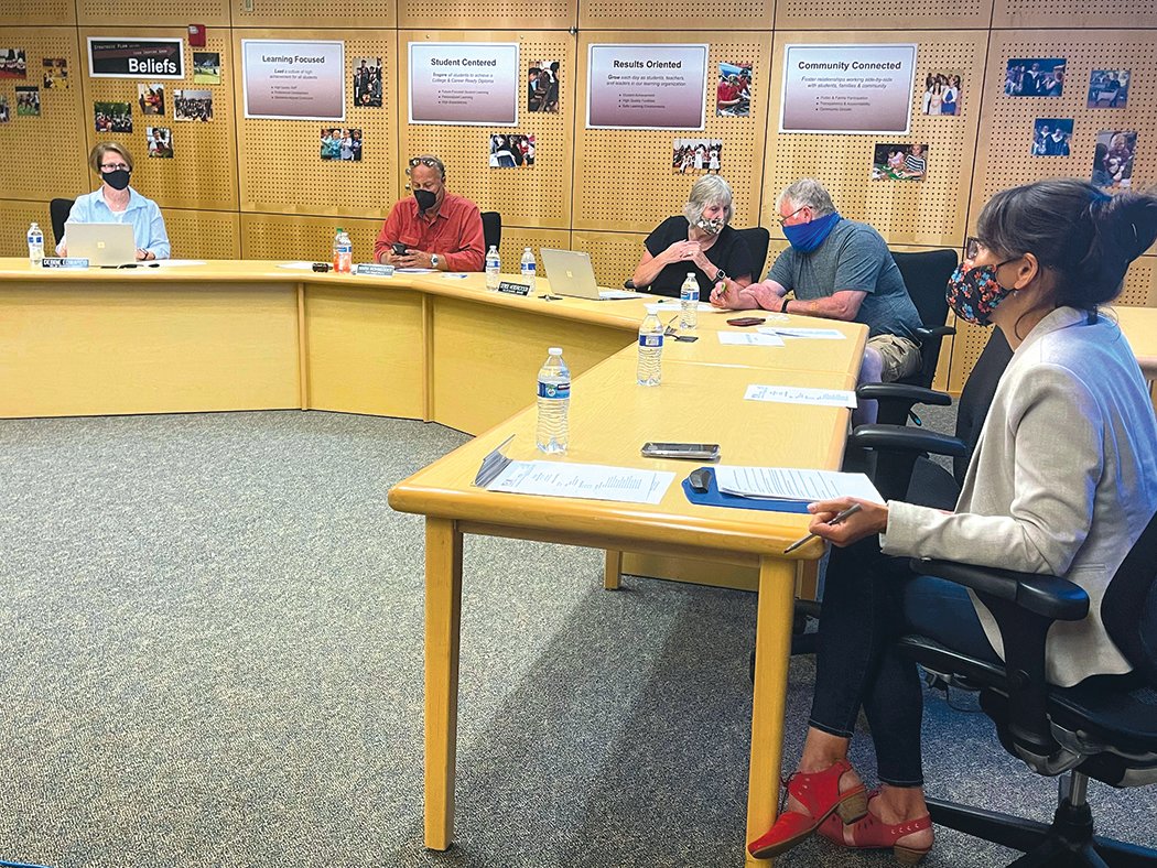 Councilmembers chat before the July 22 Yelm Community Schools board of directors meeting.