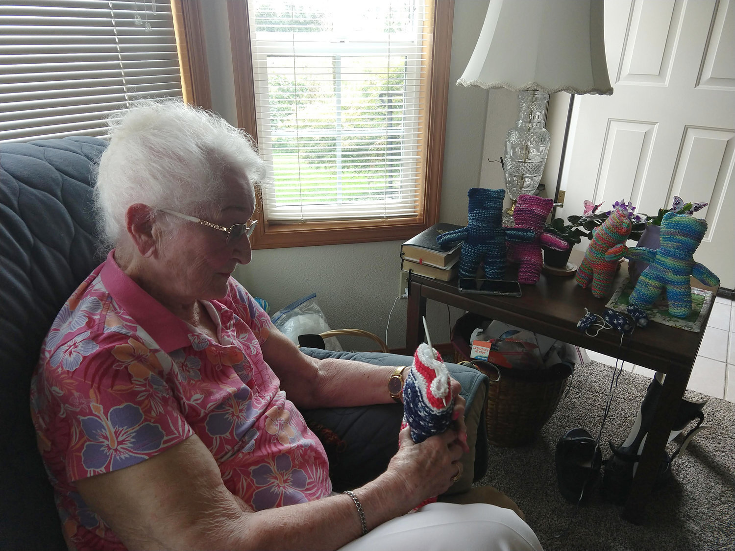 Shirley (French) Nelson, who turned 100 in July, holds a “prayer bear” that she knitted in this recent photo.