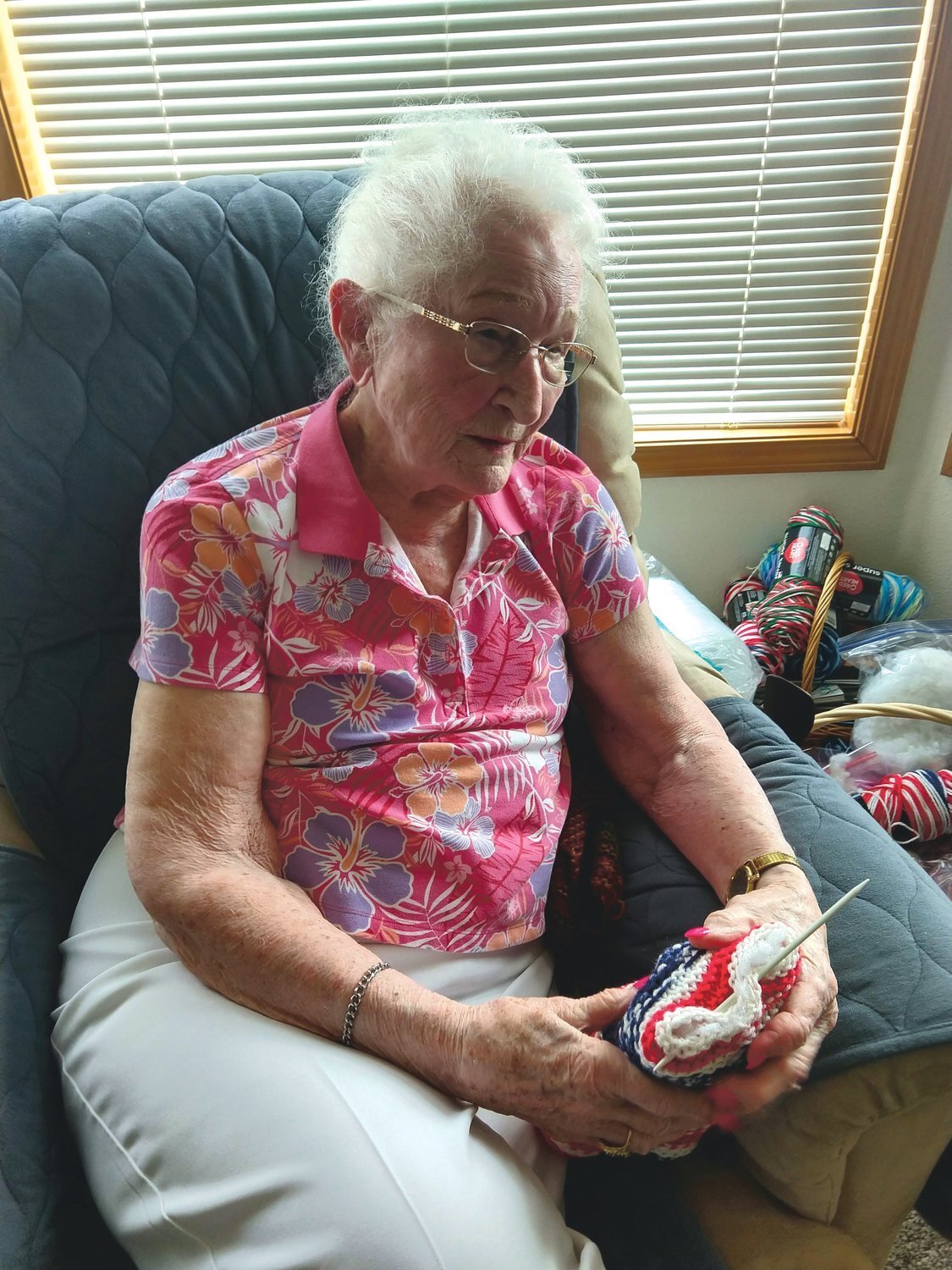 Shirley (French) Nelson, who turned 100 in July, holds a “prayer bear” that she knitted in this recent photo.