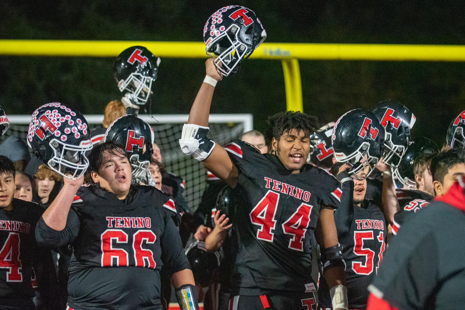 Members of the Tenino football team celebrate after defeating Castle Rock 56-0 in the district playoffs in November.