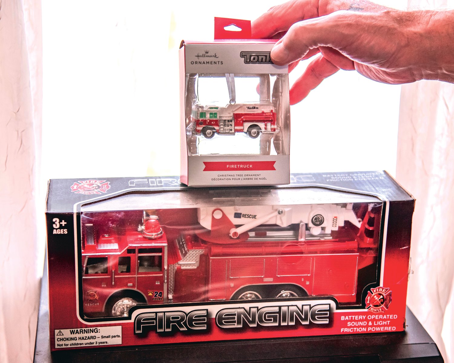 Chuck Tippett Jr. talks about a firetruck ornament his caregiver bought for him that he keeps displayed in his livingroom in a Hallmark box, Saturday in Centralia.