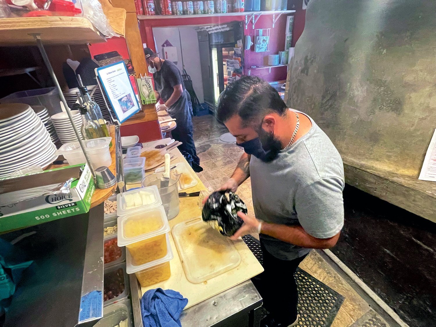 Francisco Arias, a cook at Pizzeria La Gitana of Yelm, prepares food in this file photo.