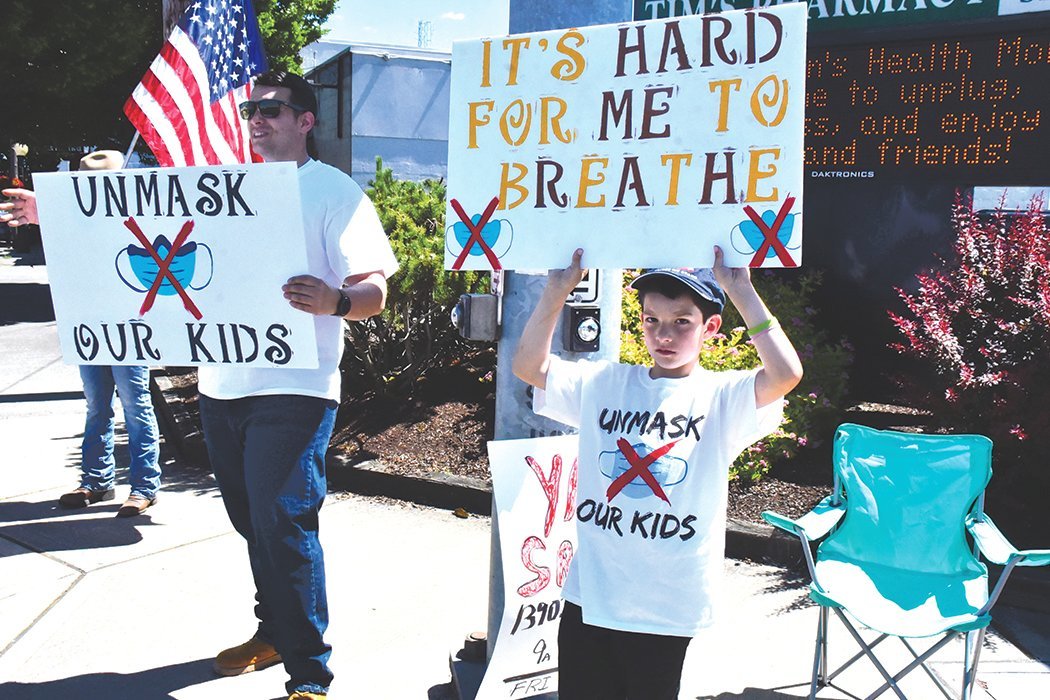 Folks came out to wave signs in opposition to children waering masks in school Saturday, June 19 at the interesection of Yelm Avenue and First Street.