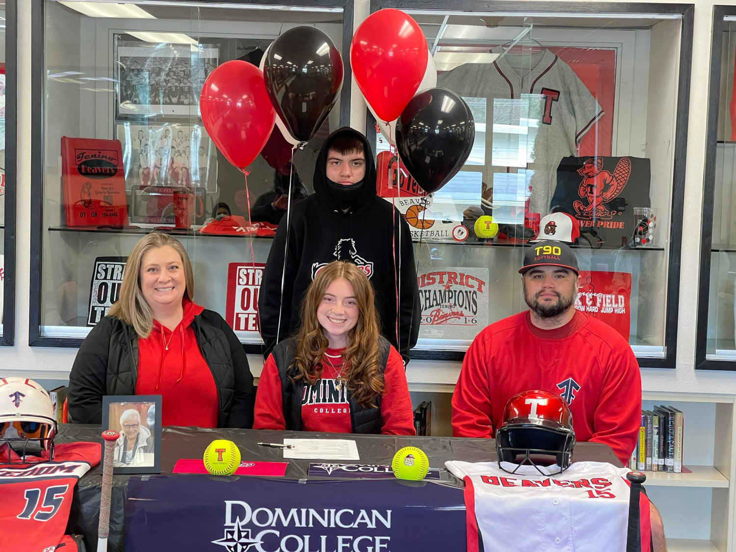 Tenino senior Emily Baxter, center, poses with her family after signing a National Letter of Intent with Dominican College softball on Thursday.