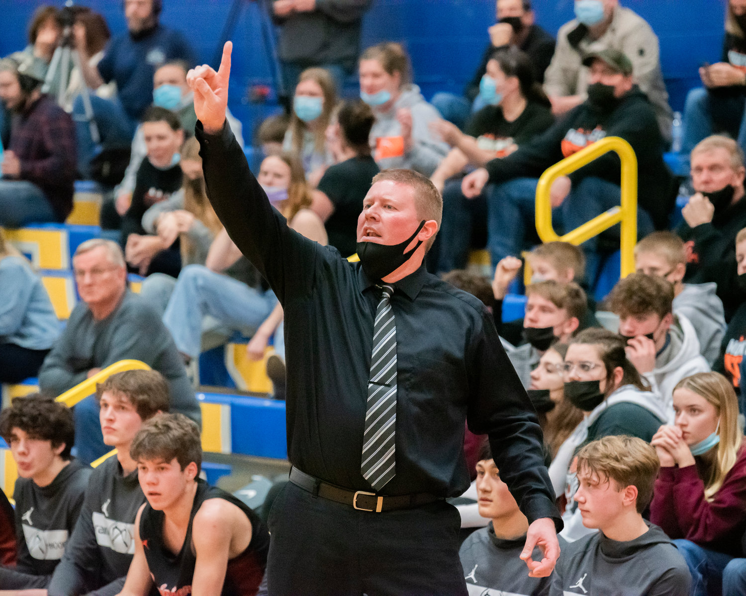 Rainier Head Coach Ben Scheaffer yells to players on the court during a game Friday night.