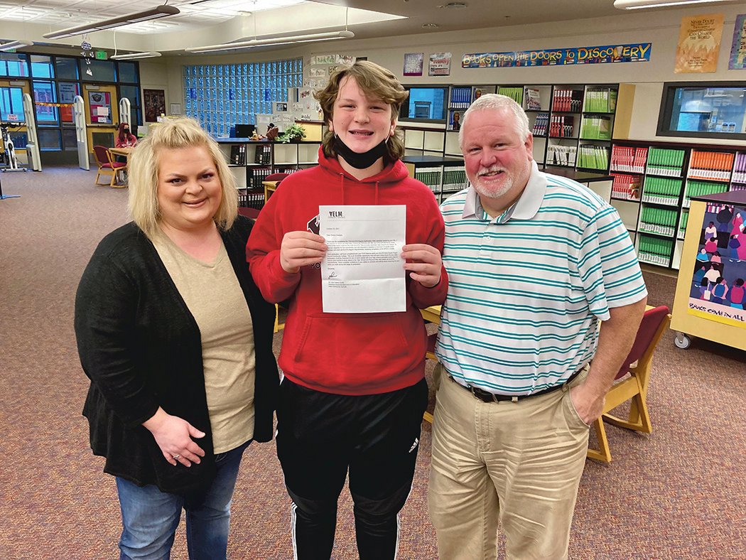 One family receives the award letter telling them of its student's acceptance into Yelm High School's associate of arts degree program.