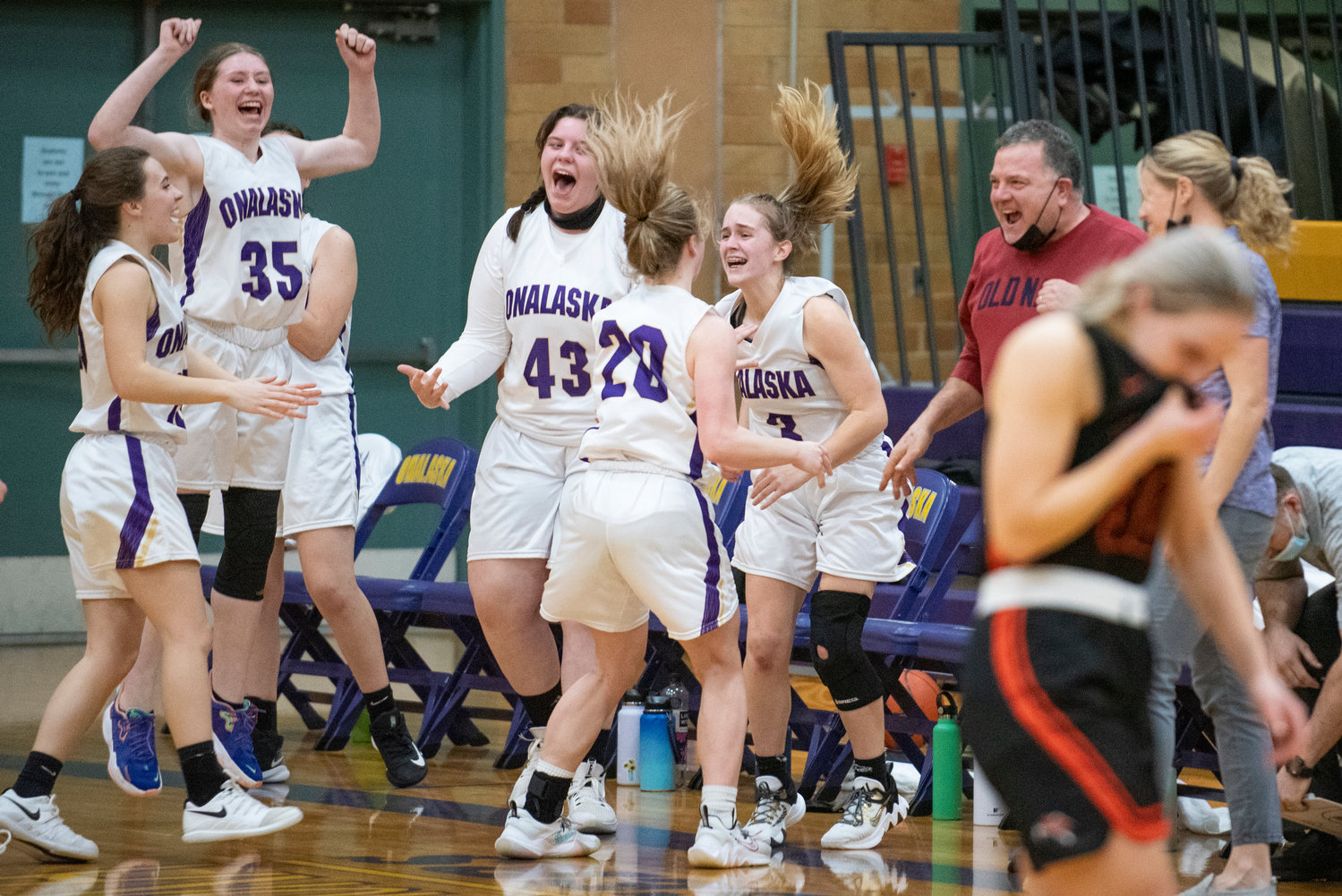 Onalaska players leap in celebration after completing a 39-37, come-from-behind victory over visiting Rainier on Jan. 20.