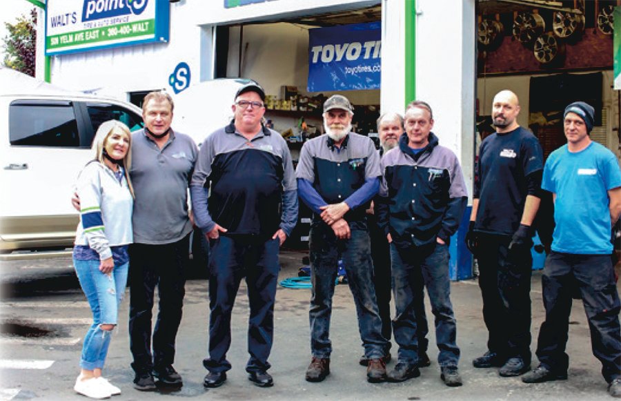 Sherri and Walt Franczyk, left, are pictured with employees of Walt’s Point S Tires in this file photo. Walt recently announced his retirement. His daughter Jennifer Palmer and her husband Gilbert will take over ownership of the shop.