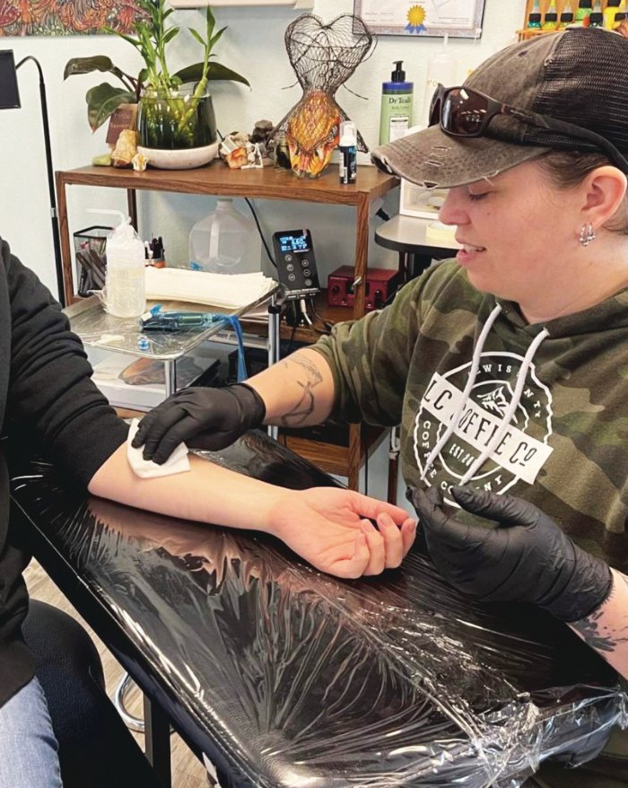 Jessa Madlock gets prep work done for a tattoo at Dancing Needles Tattoo Studio in Yelm.