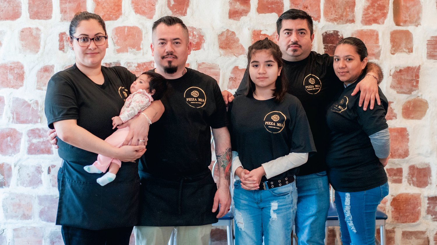 From left, Miriam  Garcia and Jose Villegas holding Amaya, 8 weeks old, pose for a photo alongside Maria, 11, Mario, and Karla Villegas at Pizza Mia in Tenino Tuesday afternoon.