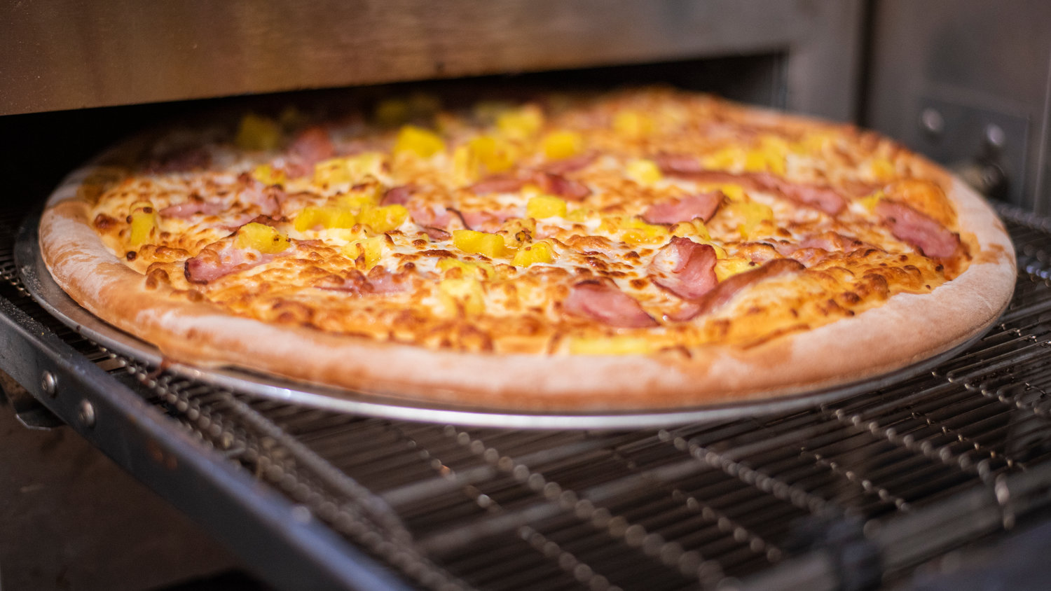 A Hawaiian Pizza is cooked on an oven at Pizza Mia in Tenino.