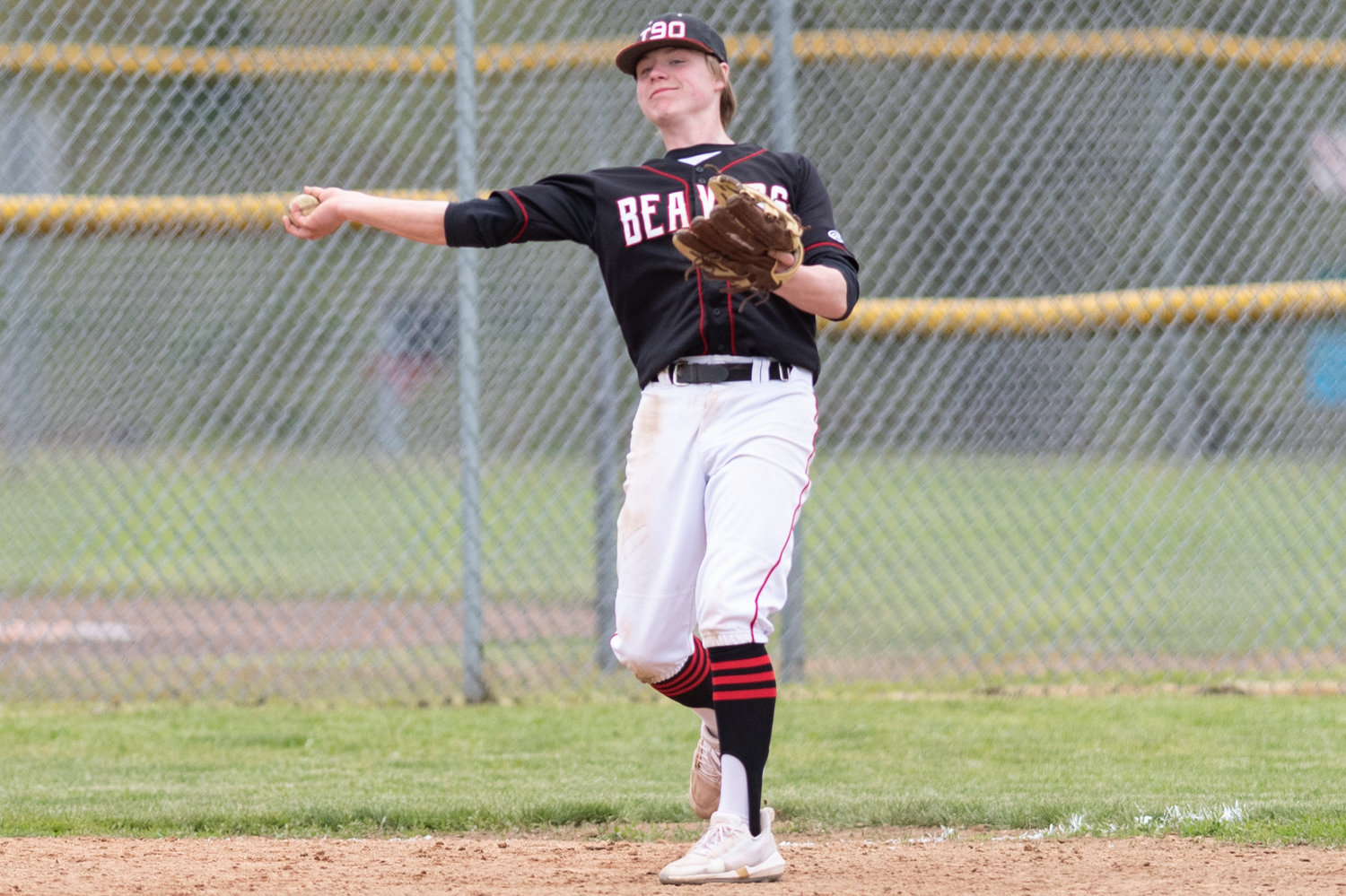 Tenino infielder Mikey Vasser throws to first against King's Way Christian May 13 in the 1A Evergreen District playoffs in Castle Rock.