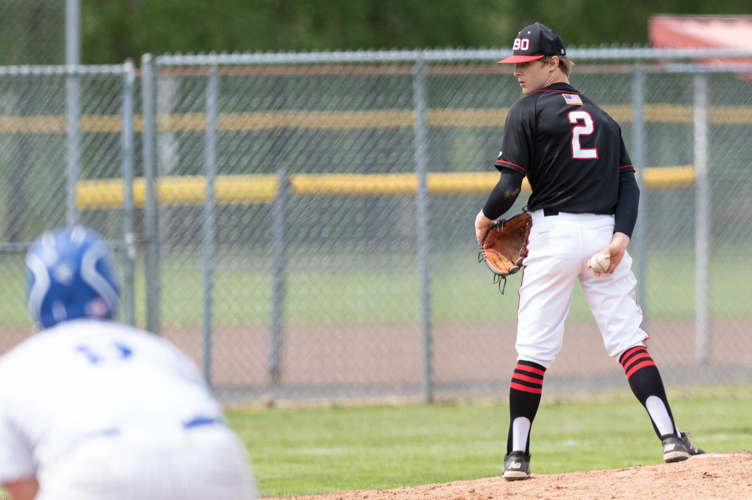 Tenino pitcher Cody Strawn eyes an Eatonville runner on first base in the 1A District 4 playoffs at Castle Rock May 13.