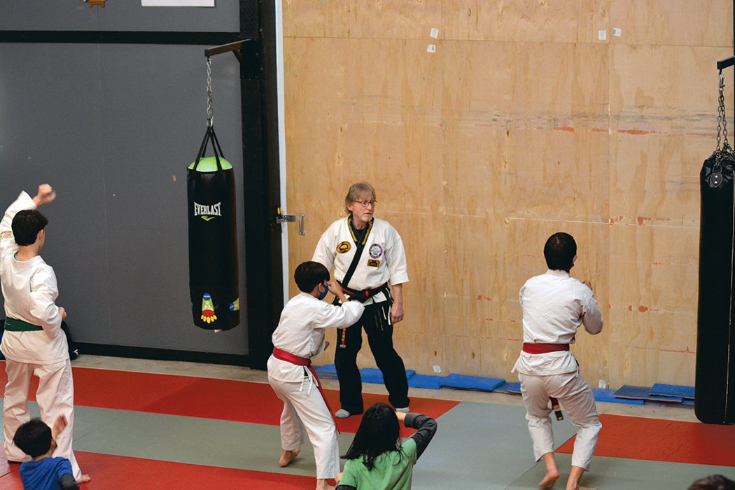 Instructor Bob Aubrey demonstrates techniques to several students at Rainier Martial Arts.