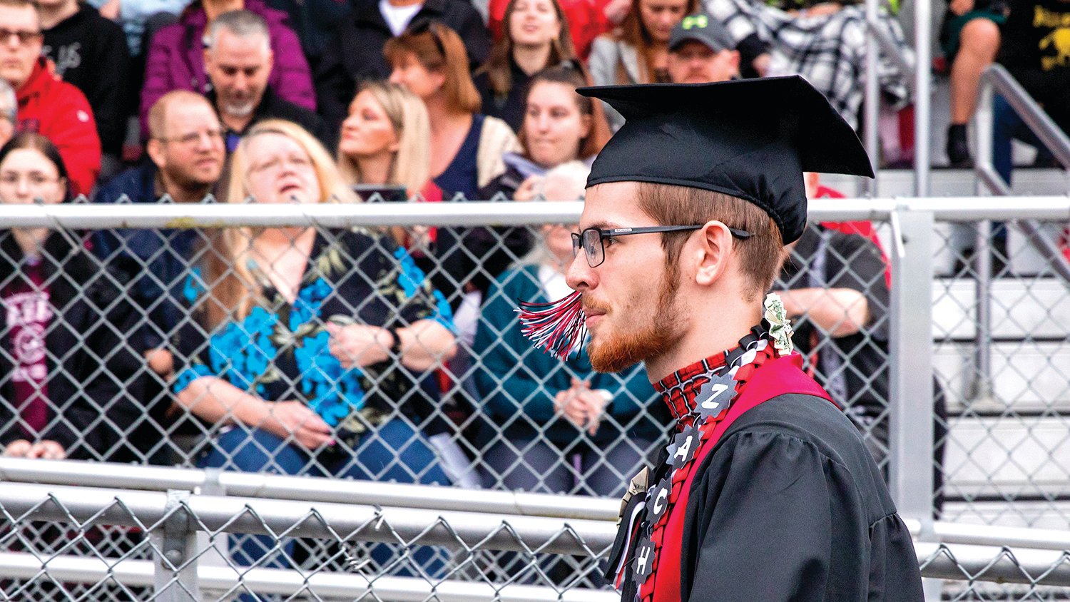 Zach, a graduate at Tenino High School, walks into Beaver Stadium sporting a cap and gown before receiving his diploma on Friday.