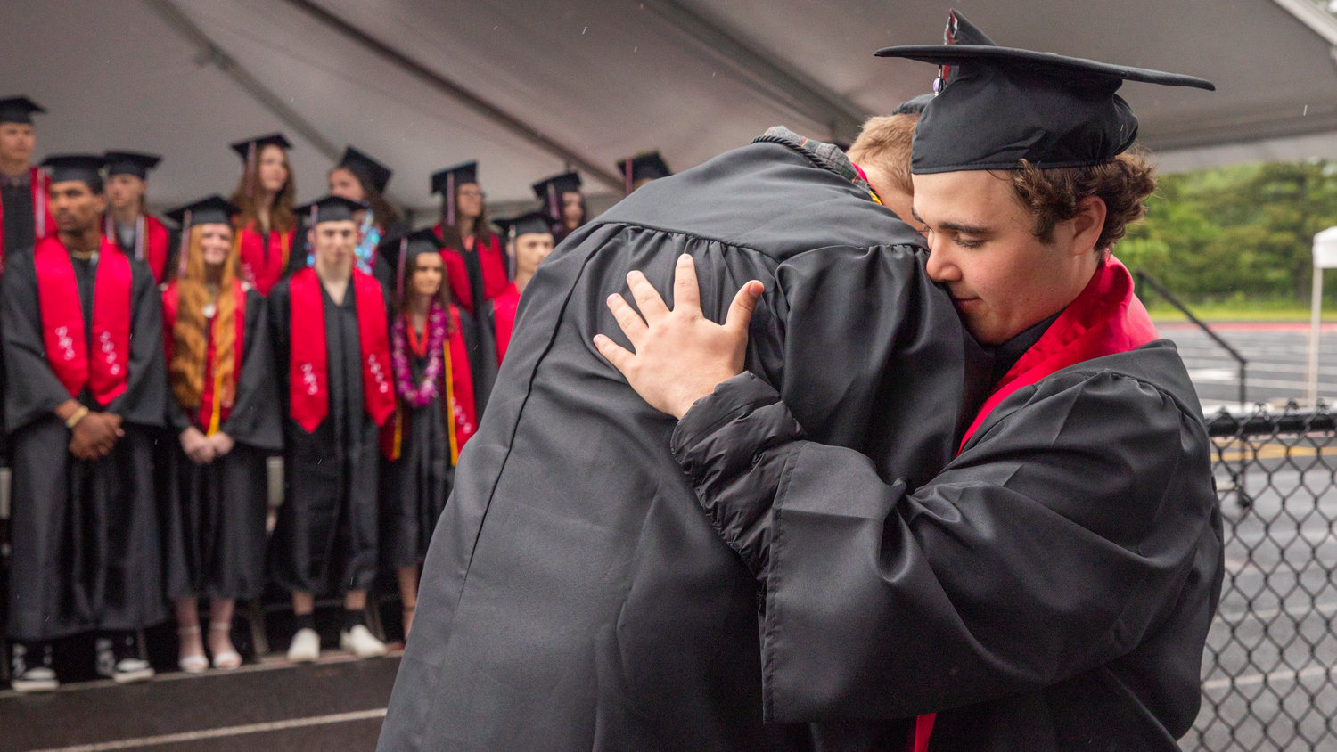 Graduates embrace before receiving their diplomas in Tenino.