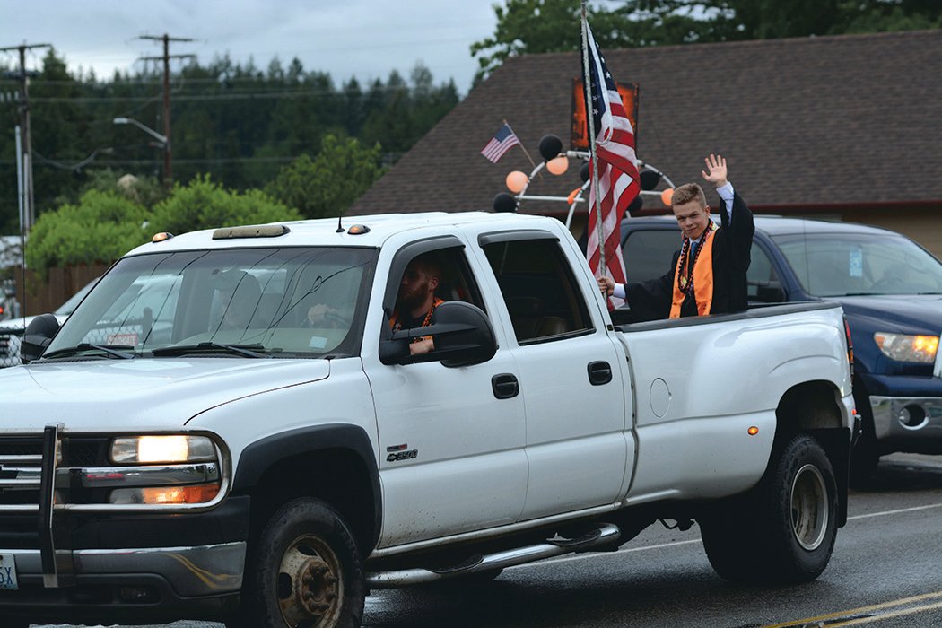 Rainier High School graduate Cade Jerke waves during a parade on June 10 from the back of a truck.