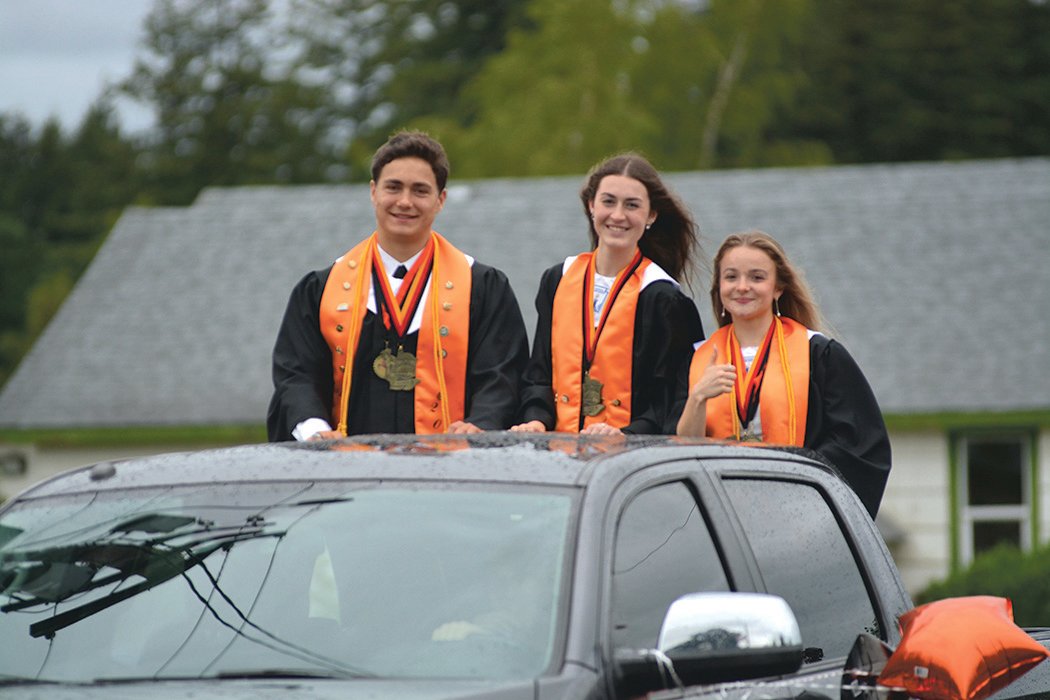 Rainier valedictorians Jeremiah Nubbe, Faith Boesch and Selena Niemi pose for a photo in a pick-up truck on June 10.