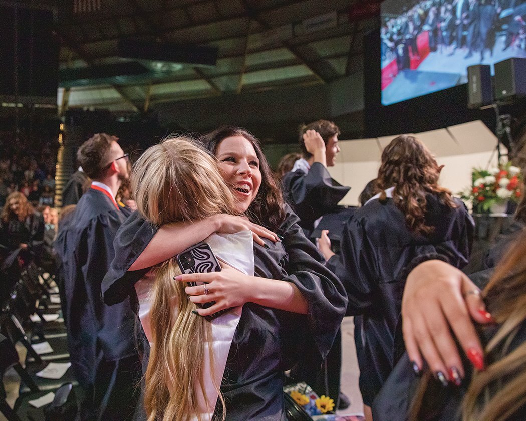 A graduate from Yelm High School receives a hug during the commencement ceremony at the Tacoma Dome on June 16.