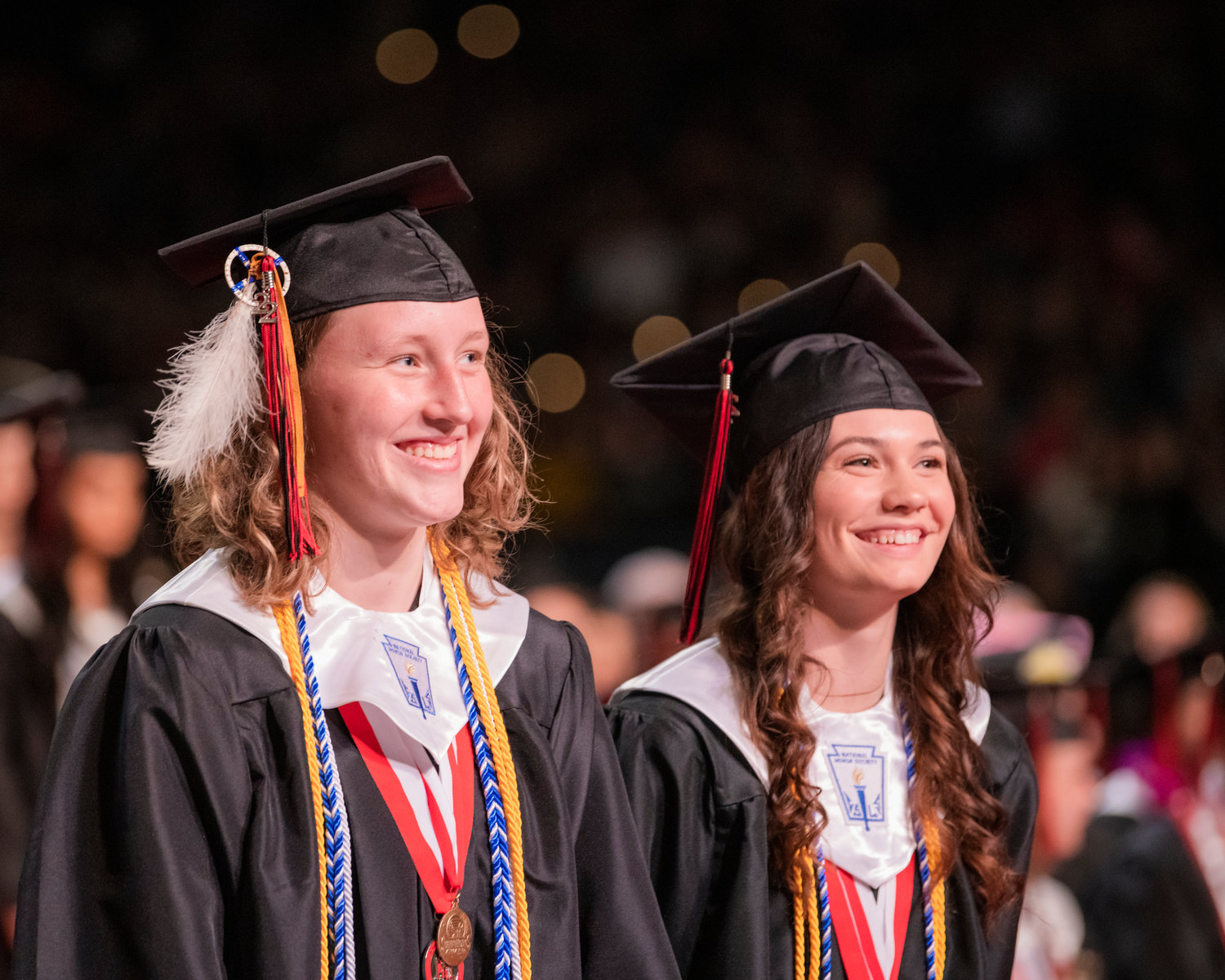 Two graduates from Yelm High School smile at the Tacoma Dome on June 16.