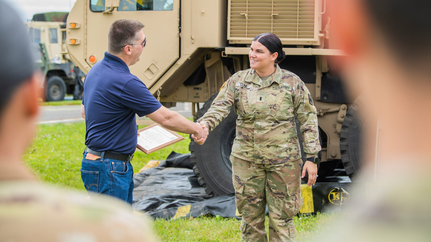 Brandon Rakes is recognized with a certificate of appreciation from Apollo Company as he shakes hands with United States Army First Lieutenant Savannah Cline at the Chehalis-Centralia Airport during a military training exercise on Wednesday, June 22 in Chehalis.