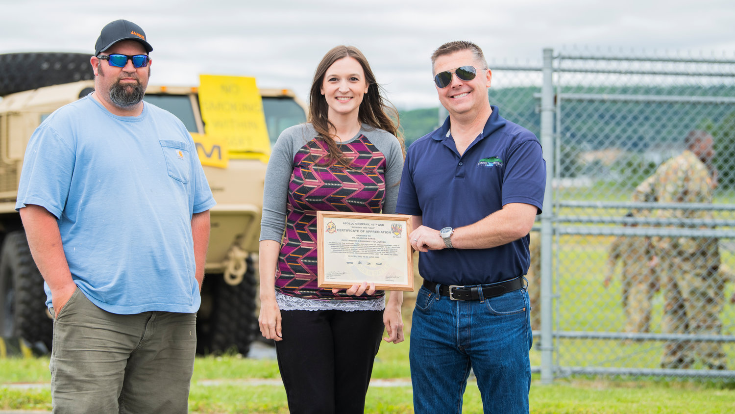 From left, Austin Barnes, Tara Sawyer, and Brandon Rakes pose for a photo with a certificate of appreciation from Apollo Company at the Chehalis-Centralia Airport during a military training exercise on Wednesday, June 22.