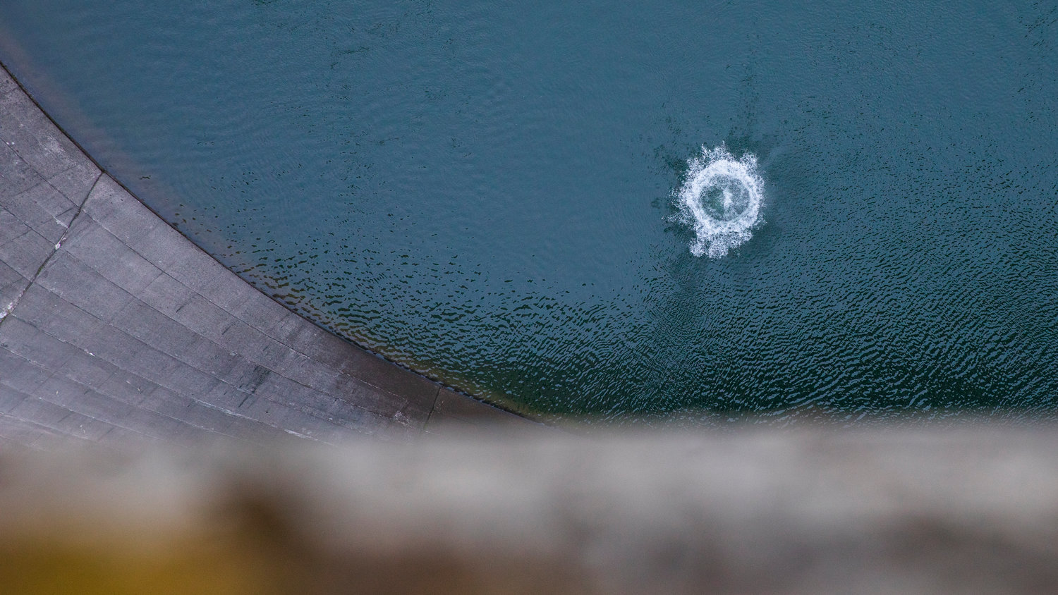 A rock makes a loud splash after being dropped from the top of the Mossyrock Dam. The dam is the tallest in the state and from bedrock to top is taller than the space needle.