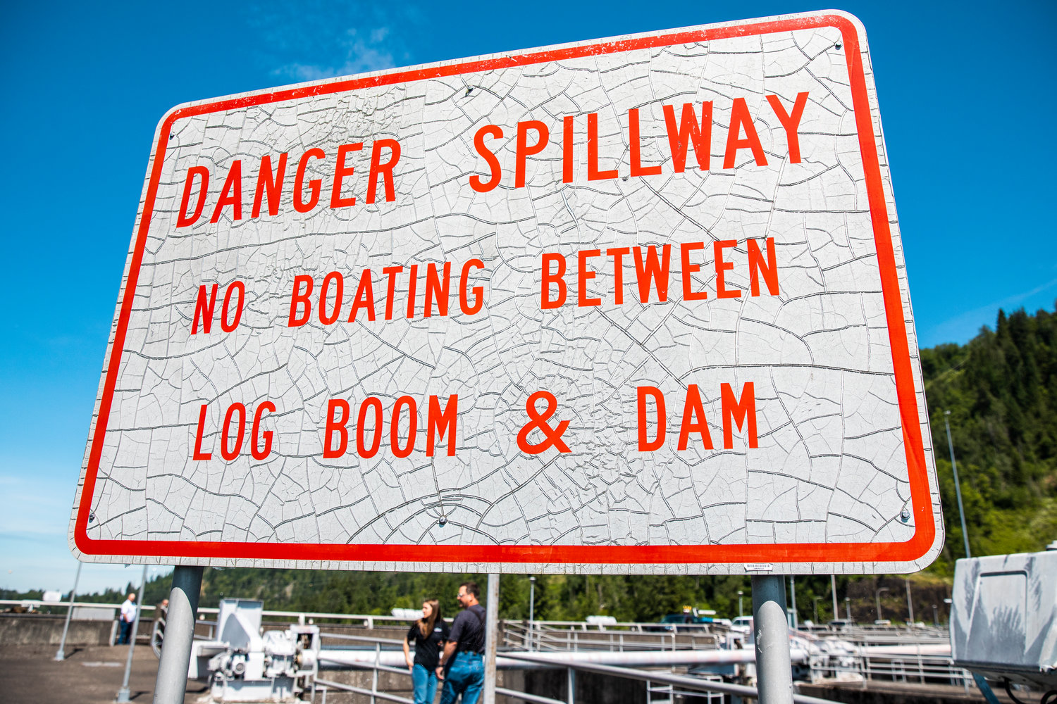 Signage is displayed in the sun on the Mossyrock Dam.
