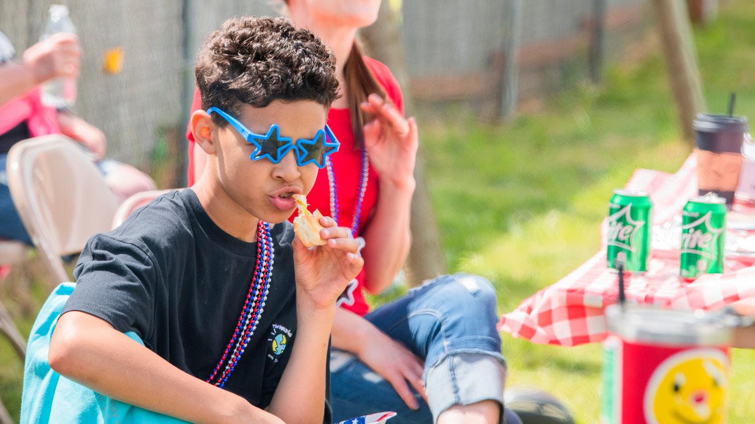 Malik Culver eats a hot dog during an event held Saturday at the Lions Den Campground in Mineral.