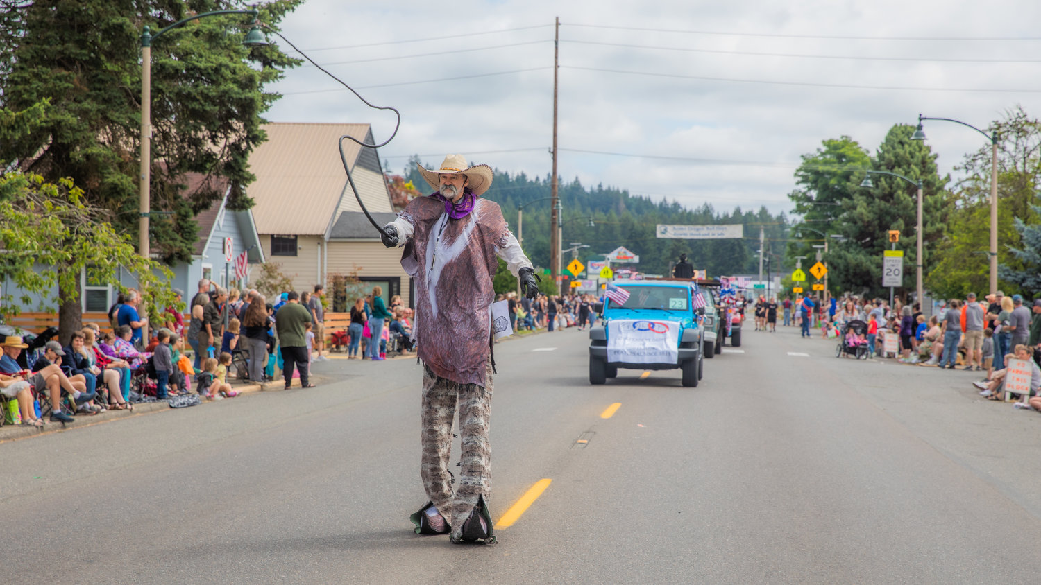 A tall cowboy cracks a whip in downtown Tenino during the Oregon Trail Days parade on Saturday.