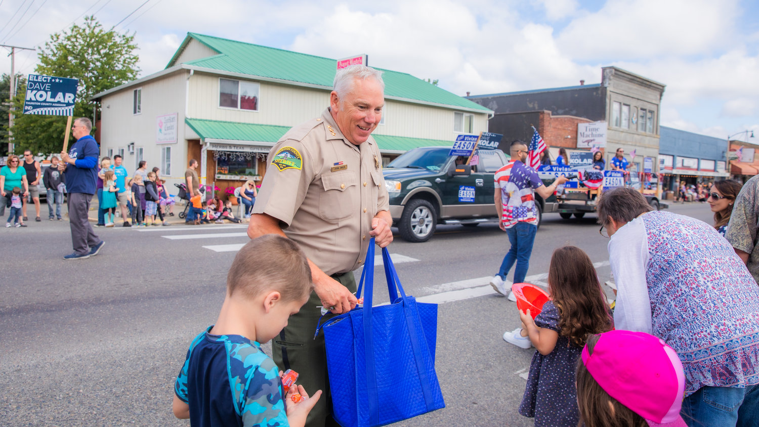 Thurston County Sheriff John Snaza smiles while passing out candy during the Oregon Trail Days parade on Saturday.