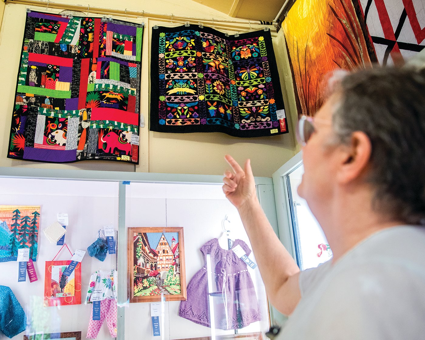 Cindy Lithrope, of Tenino, points out a quilt she designed titled, “Elephants,” which was on display during the Thurston County Fair on Thursday, July 28.